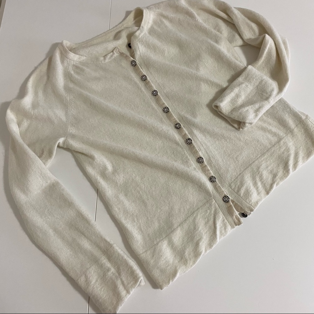 Cream cardigan sweater with jewelled buttons.